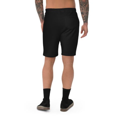 The back view of a man wearing black Men's Fleece Shorts with tattoos.