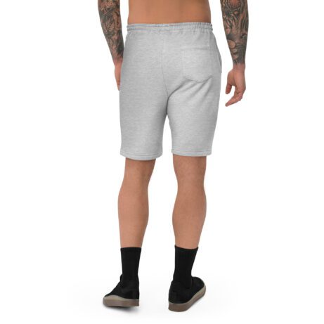 The back view of a man wearing Men's fleece shorts with tattoos.